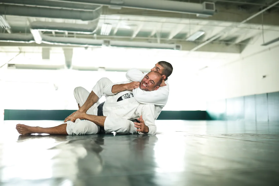 A practitioner demonstrating a back-control technique