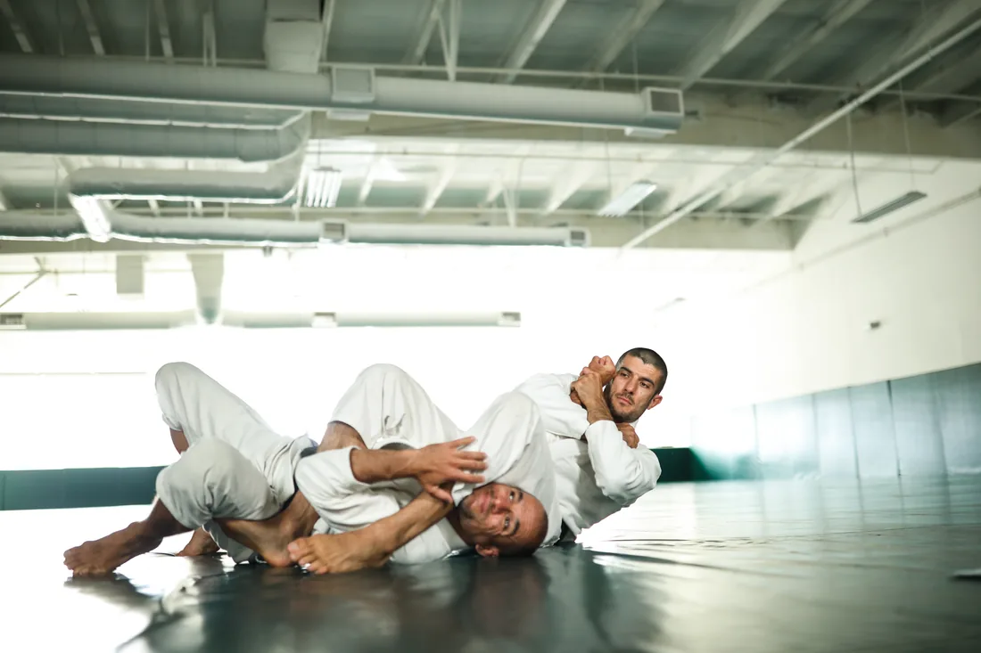 Demonstrating a straight armlock from mount during training